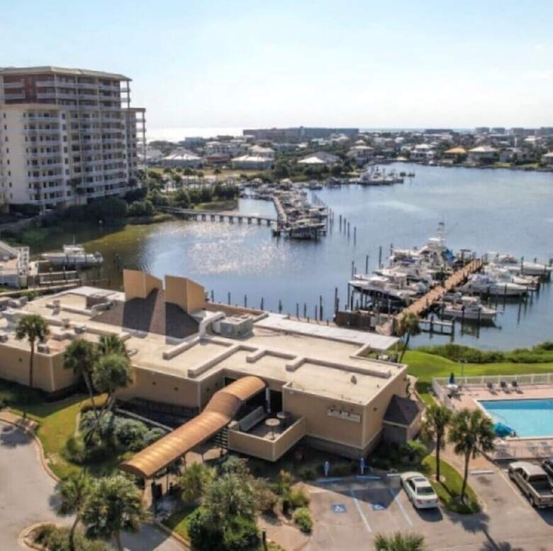 Aerial of Louisiana Lagniappe restaurant on the harbor at Sandpiper Cove with the marina and heated pool