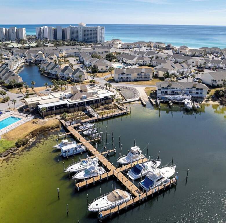 Aerial of fishing boats docked at the Sandpiper Cove marina near Destin Harbor