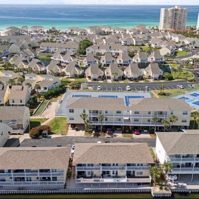 Aerial of Sandpiper Cove resort with the emerald Gulf of Mexico behind it